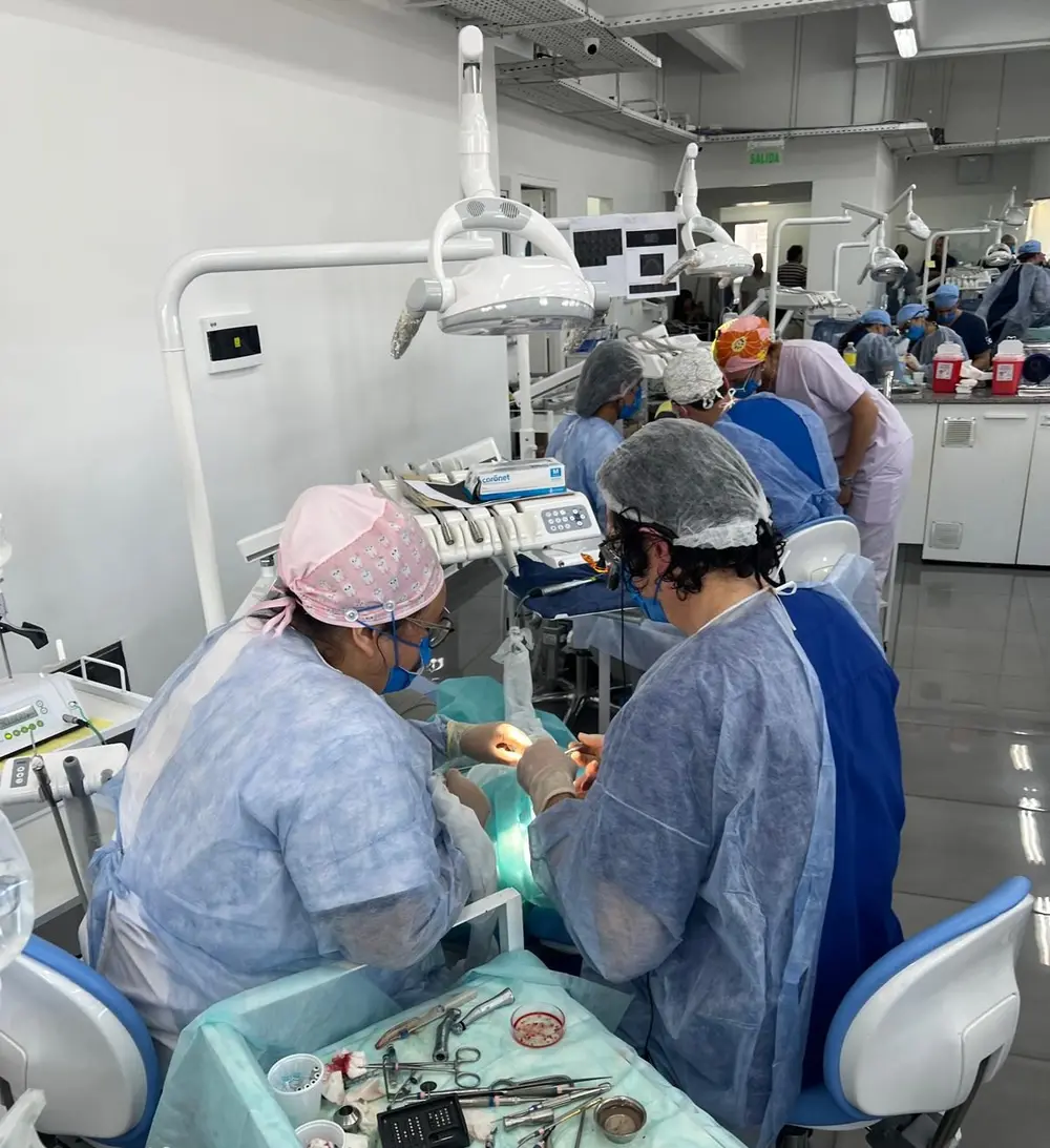 A participant operating on a real patient during the Denver course